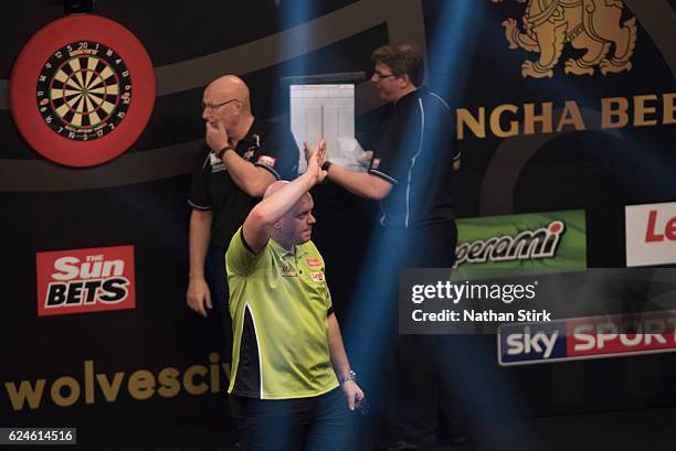 Michael van Gerwen of the Netherlands plays a shot in his semi-final match against Peter Wright of Scotland during the SINGHA Beer Grand Slam of...