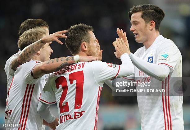 Hamburg's midfielder Nicolai Mueller celebrates scoring the 2-2 goal with his teammates during the German first division Bundesliga football match...