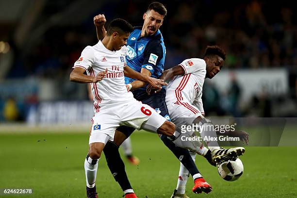 Sandro Wagner of Hoffenheim and Justino Do Santos and Gideon Jung of Hamburg battle for the ball during the Bundesliga match between TSG 1899...