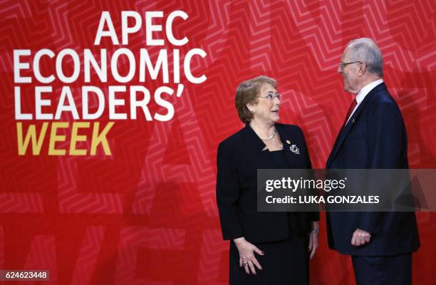 Chile's President Michelle Bachelet and Peru's President Pedro Pablo Kuczynski smile upon arrival at the Lima Convention Centre for the APEC Leaders'...