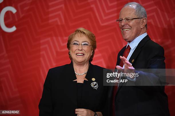 Chile's President Michelle Bachelet and Peru's President Pedro Pablo Kuczynski smile upon arrival at the Lima Convention Centre for the APEC Leaders'...