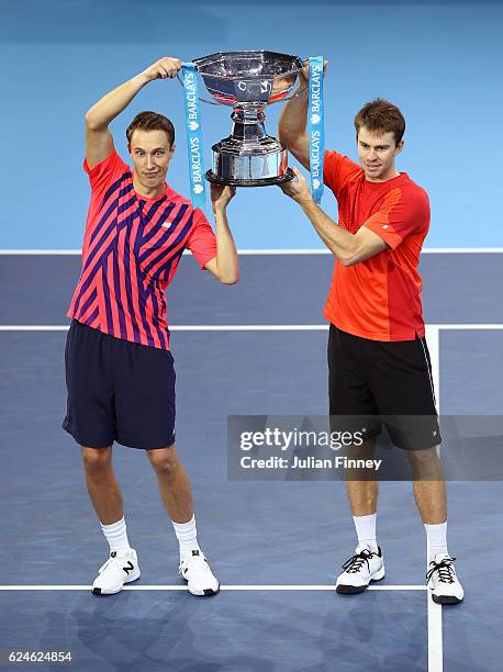 Champions Henri Kontinen of Finland and John Peers of Australia lift the trophy following the Doubles Final against Raven Klaasen of South Africa and...