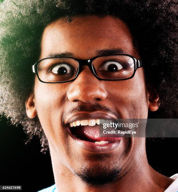 happy young wide-eyed geek plays the fool, sticking tongue out - human tongue stock pictures, royalty-free photos & images