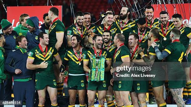 Cameron Smith of Australia celebrates with the trophy and team mates after victory in the Four Nations Final between New Zealand and Australia at...