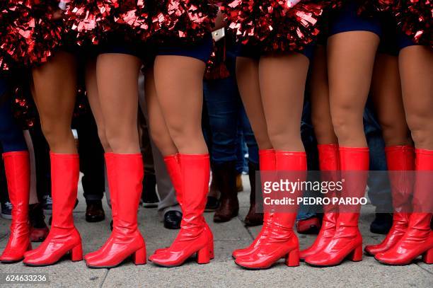 Texans' cheerleaders pose in the roundabout of the Angel of the independence in Mexico City, on November 20, 2016. - As the NFL returns to Mexico...