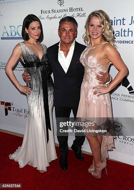 Actresses Emmanuelle Vaugier and Crystal Hunt pose with Mark Zunino at the Talk of the Town Gala 2016 at The Beverly Hilton Hotel on November 19,...