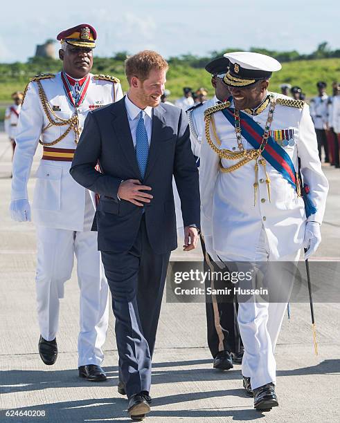 Prince Harry is greeted by the Governor General His Excellency Sir Rodney Williams as he arrives at VC Bird International Aiport on the first day of...