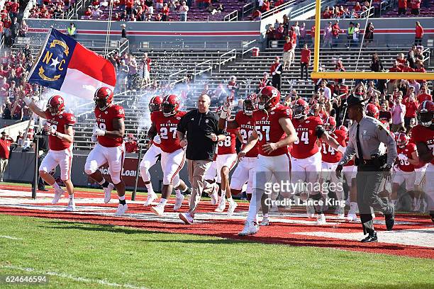 Head coach Dave Doeren of the North Carolina State Wolfpack leads his team onto the field prior to their game against the Miami Hurricanes at...