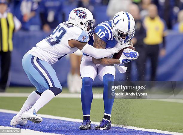 Donte Moncrief of the Indianapolis Colts is tackled by Brice McCain of the Tennessee Titans as he makes a touchdown pass during the first quarter of...