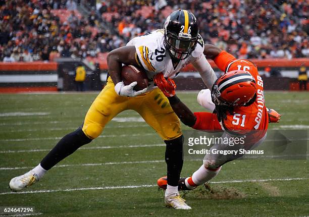 Le'Veon Bell of the Pittsburgh Steelers is pushed out of bounds by Jamie Collins of the Cleveland Browns during the second quarter at FirstEnergy...