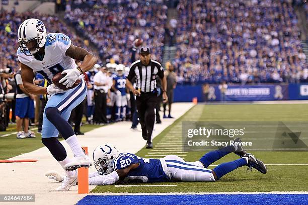 Rishard Matthews of the Tennessee Titans catches a pass in front of Darius Butler of the Indianapolis Colts during the first half of a game at Lucas...