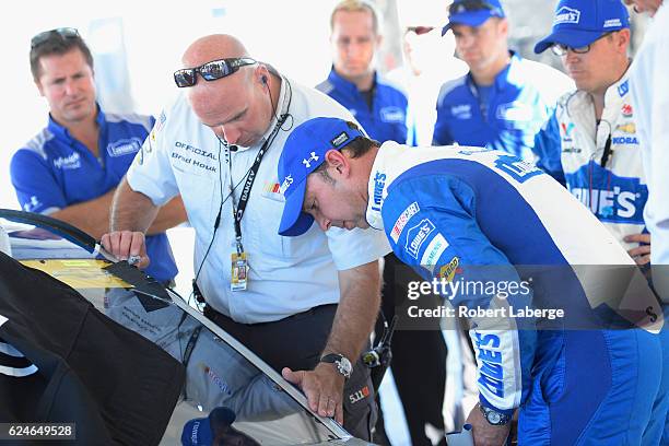 Crew chief for Jimmie Johnson, driver of the Lowe's Chevrolet, Chad Knaus speaks to a NASCAR official in the garage area during pre-race ceremonies...