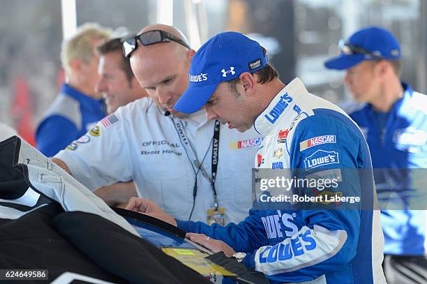 Crew chief for Jimmie Johnson, driver of the Lowe's Chevrolet, Chad Knaus speaks to a NASCAR official in the garage area during pre-race ceremonies...