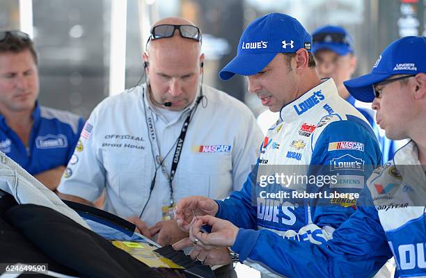 Crew chief for Jimmie Johnson, driver of the Lowe's Chevrolet, Chad Knaus speaks to a NASCAR official in the garage area during pre-race ceremonies...
