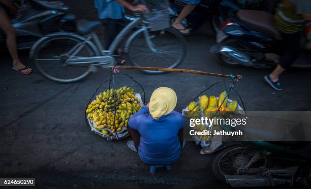immigrant woman earn money by banana street vendor - vietnamese street food stock pictures, royalty-free photos & images