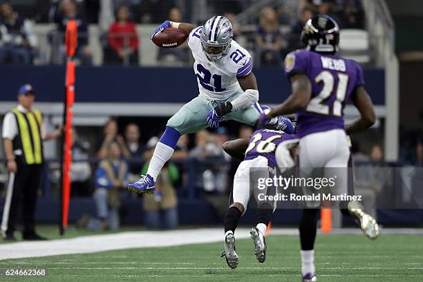 Ezekiel Elliott of the Dallas Cowboys leaps over Tavon Young of the Baltimore Ravens during the third quarter of their game at AT&T Stadium on...