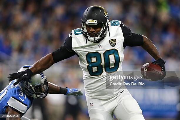 Julius Thomas of the Jacksonville Jaguars runs for yardage against Rafael Bush of the Detroit Lions during second half action at Ford Field on...