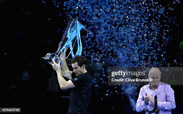 Andy Murray of Great Britain reacts as a the ticker tape canon fires as he starts to lift the trophy following his victory during the Singles Final...