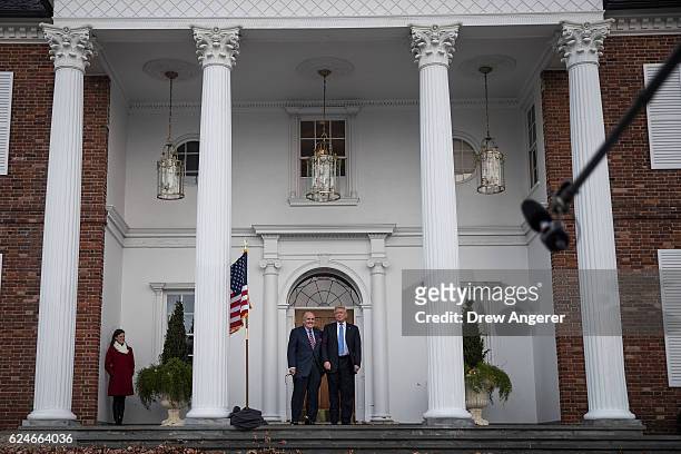 Former New York City mayor Rudy Giuliani stands with president-elect Donald Trump before their meeting at Trump International Golf Club, November 20,...