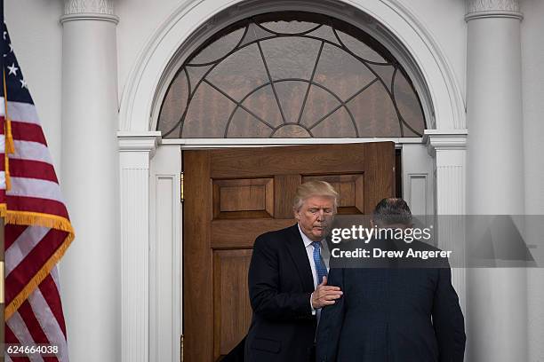 President-elect Donald Trump and former New York City mayor Rudy Giuliani head into the clubhouse for their meeting at Trump International Golf Club,...