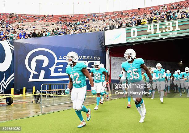 Kenyan Drake and Walt Aikens of the Miami Dolphins lead their team to the field for warm ups before the game against the Los Angeles Rams at Los...