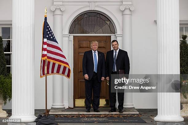 President-elect Donald Trump and Kris Kobach, Kansas secretary of state, pose for a photo following their meeting with president-elect at Trump...