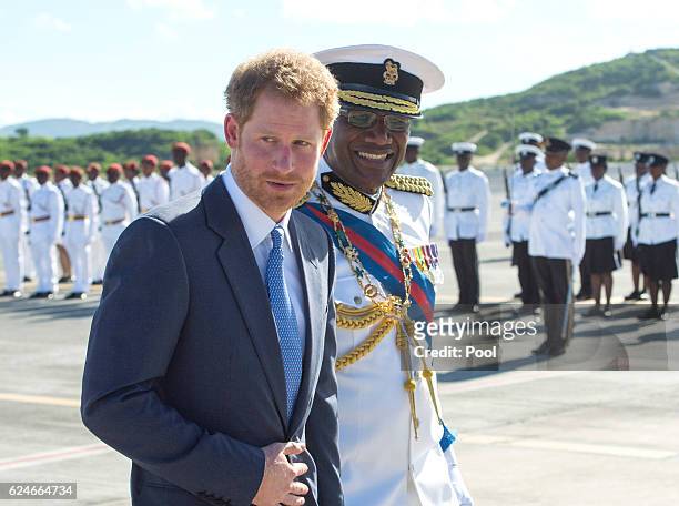 Prince Harry is greeted by the Governor General His Excellency Sir Rodney Williams as he arrives at VC Bird International Aiport on the first day of...