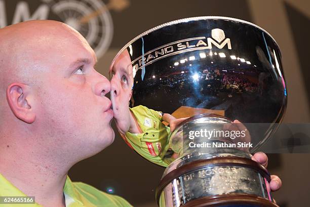 Michael van Gerwen of the Netherlands is awarded the SINGHA Beer Grand Slam of Darts after the game against James Wade at Wolverhampton Civic Hall on...