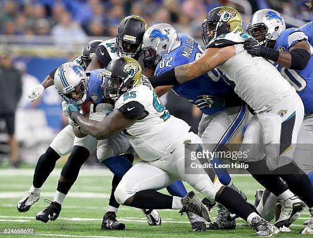Theo Riddick of the Detroit Lions is gang tackled by the Jacksonville Jaguars during fourth quarter at Ford Field on November 20, 2016 in Detroit,...