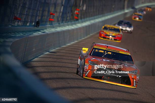 Carl Edwards, driver of the ARRIS Toyota, leads a pack of cars during the NASCAR Sprint Cup Series Ford EcoBoost 400 at Homestead-Miami Speedway on...