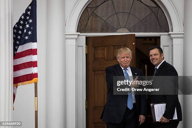 President-elect Donald Trump and Kris Kobach, Kansas secretary of state, pose for a photo following their meeting with president-elect at Trump...