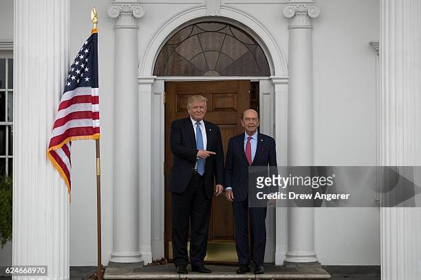 President-elect Donald Trump and investor Wilbur Ross pose for a photo following their meeting at Trump International Golf Club, November 20, 2016 in...