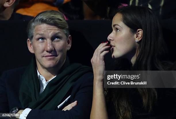 Bastian Schweinsteiger and Ana Ivanovic attend the Singles Final between Novak Djokovic of Serbia and Andy Murray of Great Britain at the O2 Arena on...