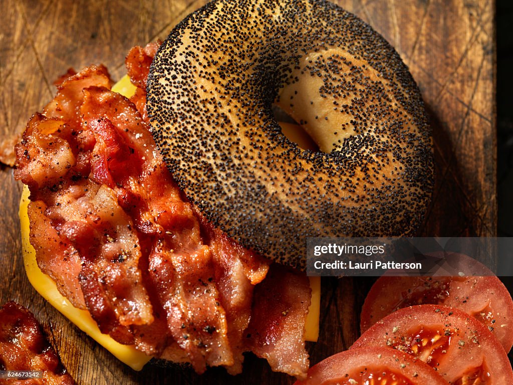 Poppyseed Bagel Sandwich with Bacon, Cheese and Tomatoes