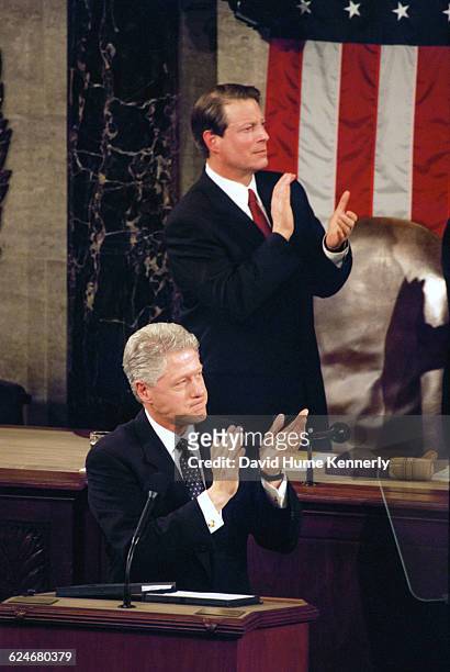 Bill Clinton and Vice President Al Gore applaud an audience member during the President's State of the Union speech before a joint session of...