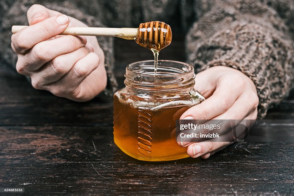 Hands holding honey