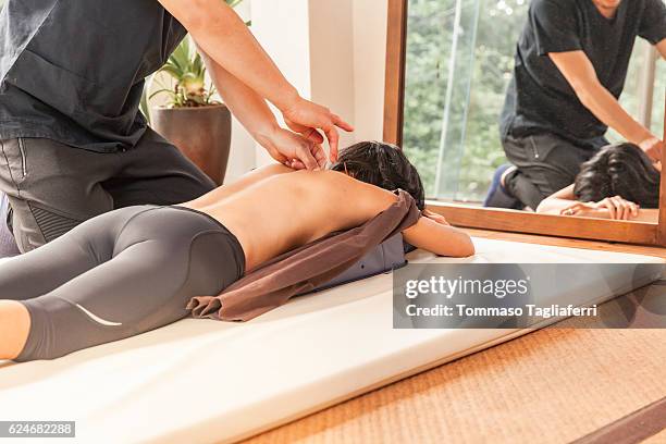 woman having an acupunture session - body massage japan stock pictures, royalty-free photos & images