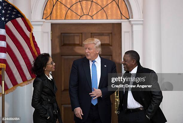 President-elect Donald Trump greets Robert Johnson , the founder of Black Entertainment Television, and his wife Lauren Wooden as they arrive for a...