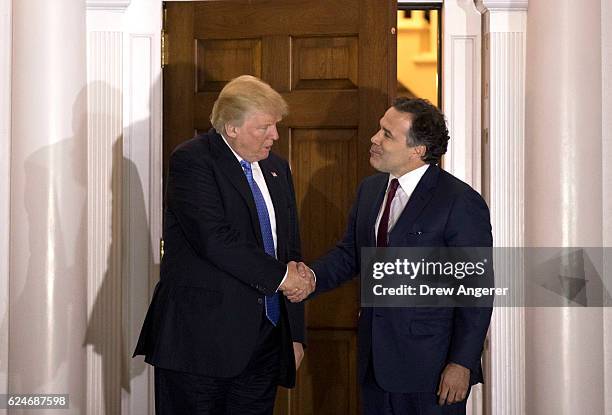 President-elect Donald Trump shakes hands with David McCormick, president of the management committee at Bridgewater Associates, following to their...