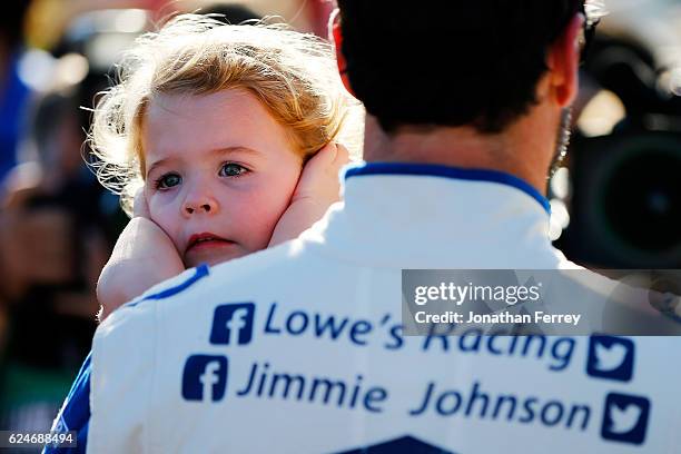 Jimmie Johnson, driver of the Lowe's Chevrolet, holds his daughter Lydia Norriss during pre-race ceremonies for the NASCAR Sprint Cup Series Ford...