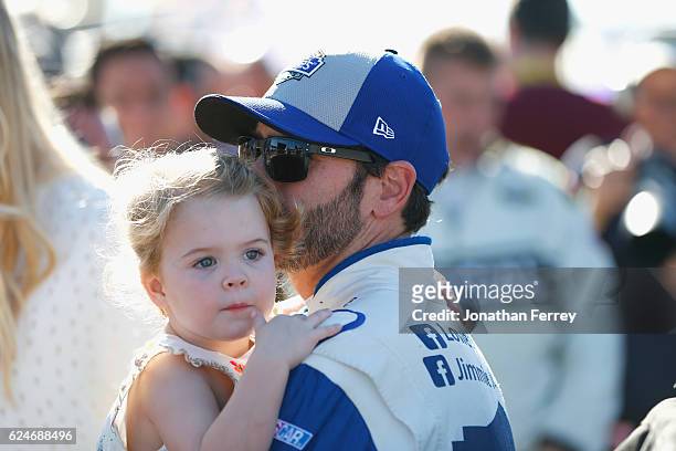 Jimmie Johnson, driver of the Lowe's Chevrolet, holds his daughter Lydia Norriss during pre-race ceremonies for the NASCAR Sprint Cup Series Ford...