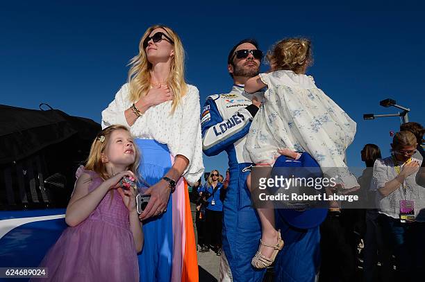 Jimmie Johnson, driver of the Lowe's Chevrolet, stands on the grid with his wife Chandra and daughters Genevieve Marie and Lydia Norriss during...