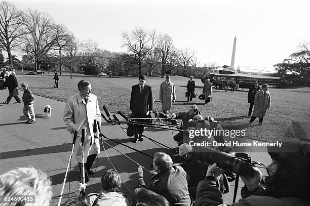 President George H.W. Bush, arriving at the White House aboard Marine One a few days before the inauguration of Bill Clinton, prepares to speak with...