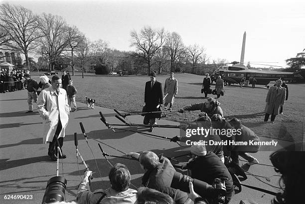 President George H.W. Bush, arriving at the White House aboard Marine One a few days before the inauguration of Bill Clinton, prepares to speak with...