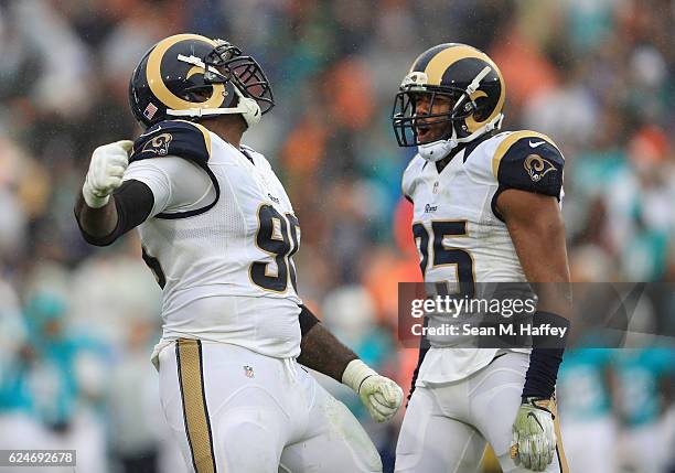 Michael Brockers of the Los Angeles Rams reacts with teammate T.J. McDonald after making a tackle in the third quarter of the game against the Miami...