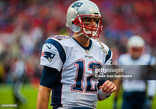 New England Patriots quarterback Tom Brady walks off the field after warming up before the regular season NFL game verses the San Francisco 49ers and...