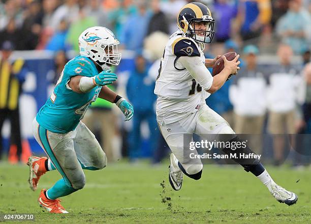 Quarterback Jared Goff of the Los Angeles Rams runs with the ball away from Spencer Paysinger of the Miami Dolphins during the third quarter of the...