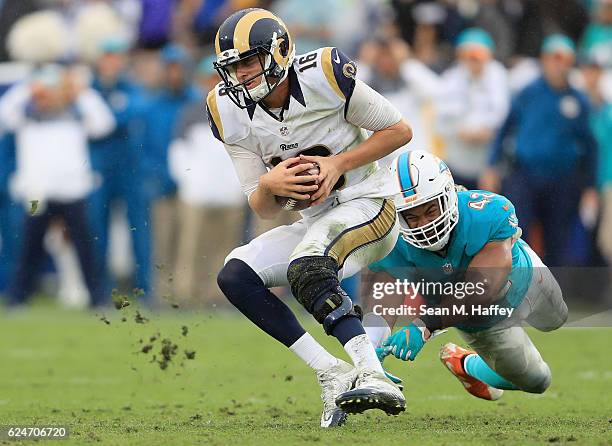 Quarterback Jared Goff of the Los Angeles Rams runs with the ball away from Spencer Paysinger of the Miami Dolphins during the third quarter of the...