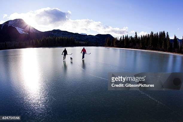 winter pond ice skate - canada hockey stock-fotos und bilder