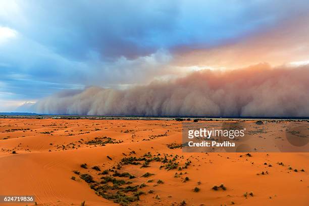 sandstorm approaching merzouga settlement,in erg chebbi desert morocco,africa - blowing dust stock pictures, royalty-free photos & images